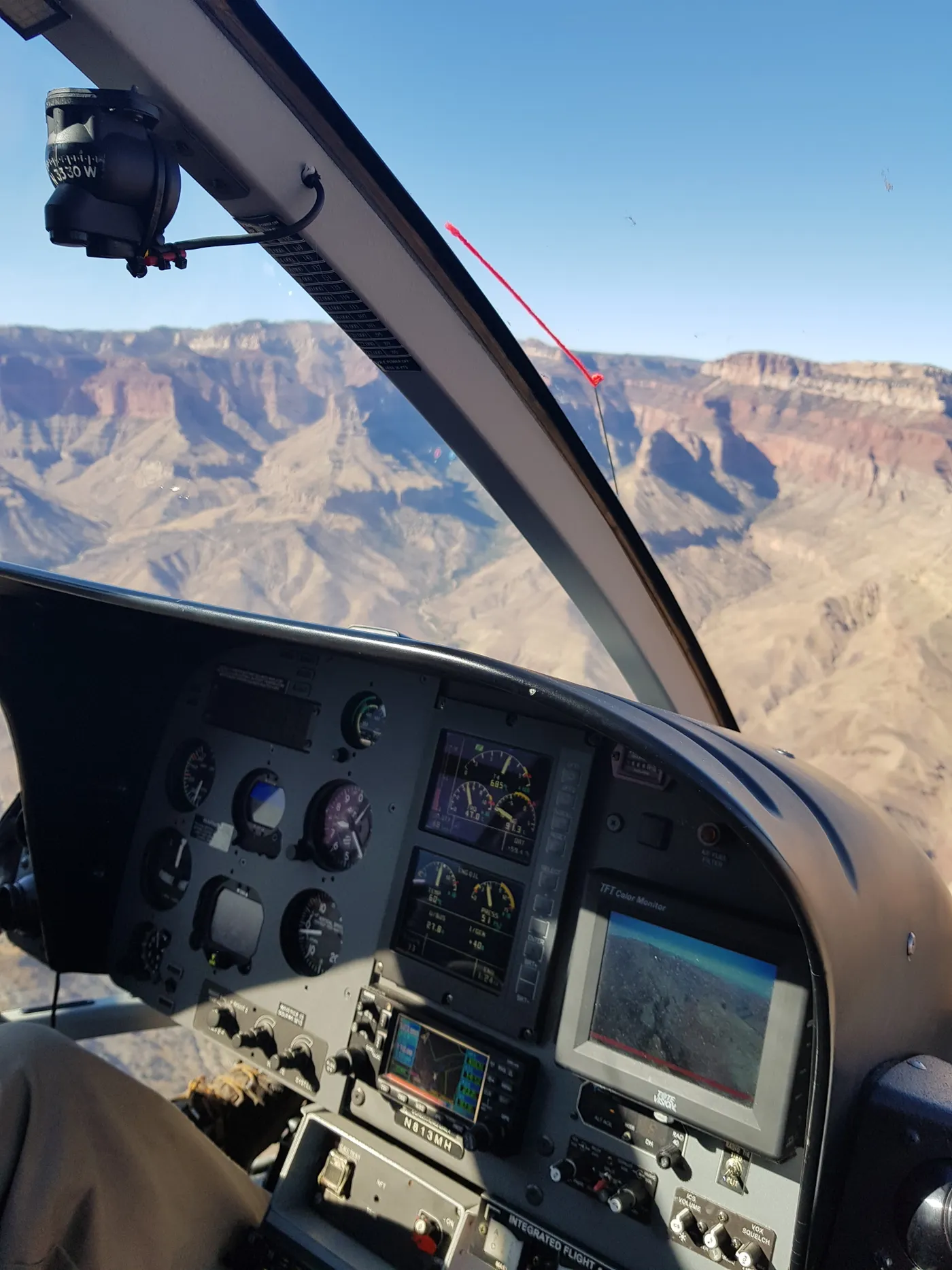 Helicopter cockpit flying over the Grand Canyon