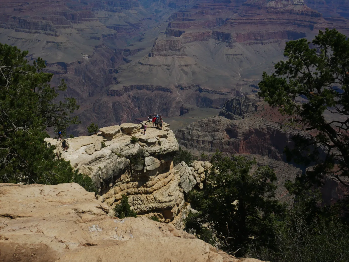 Visitors standing on the rim of the Grand Canyon